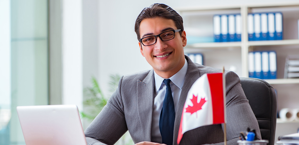 Smiling man in suit and Canadian flag