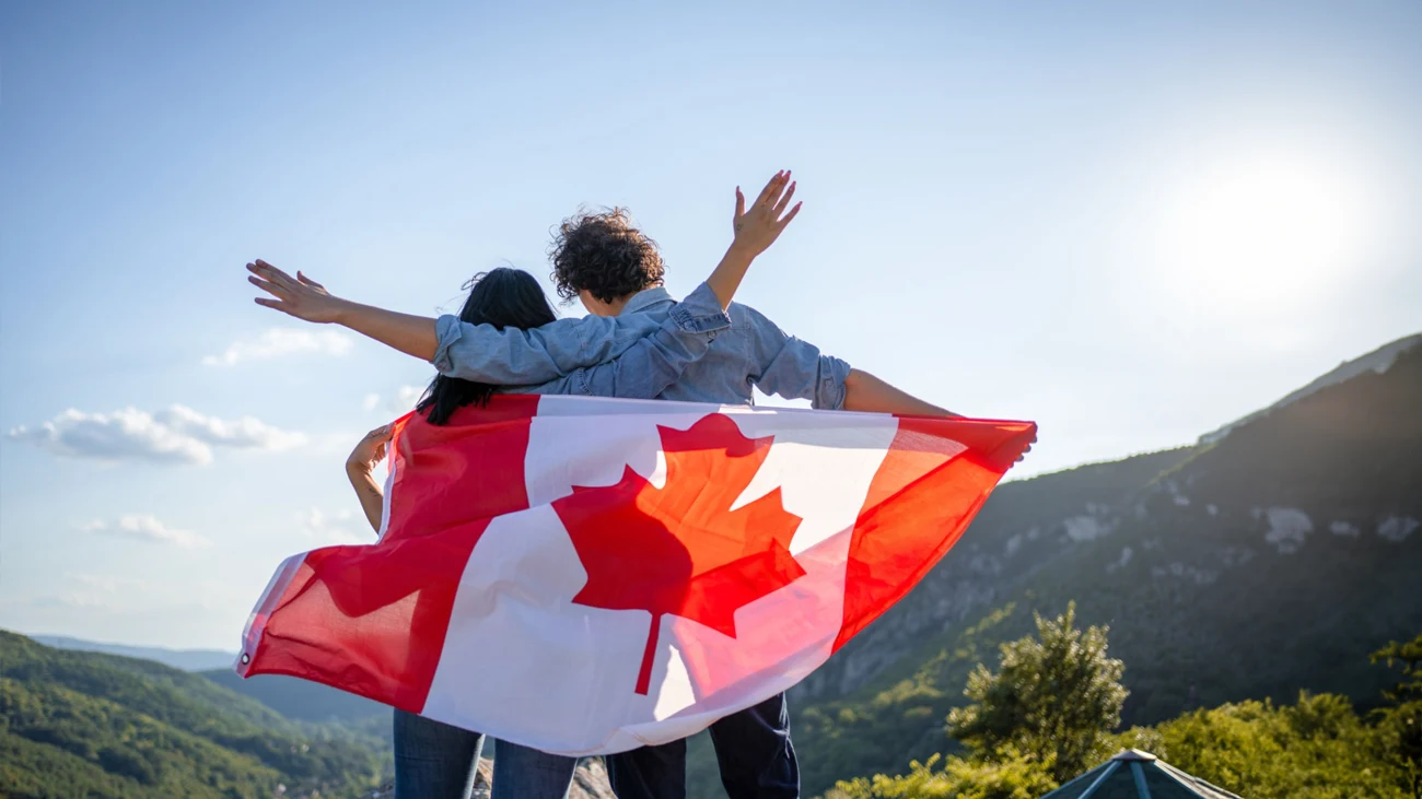 couple in the mountain with canadian flag